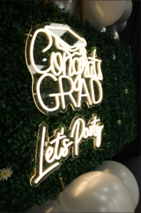 sign displaying congrats grad lets party